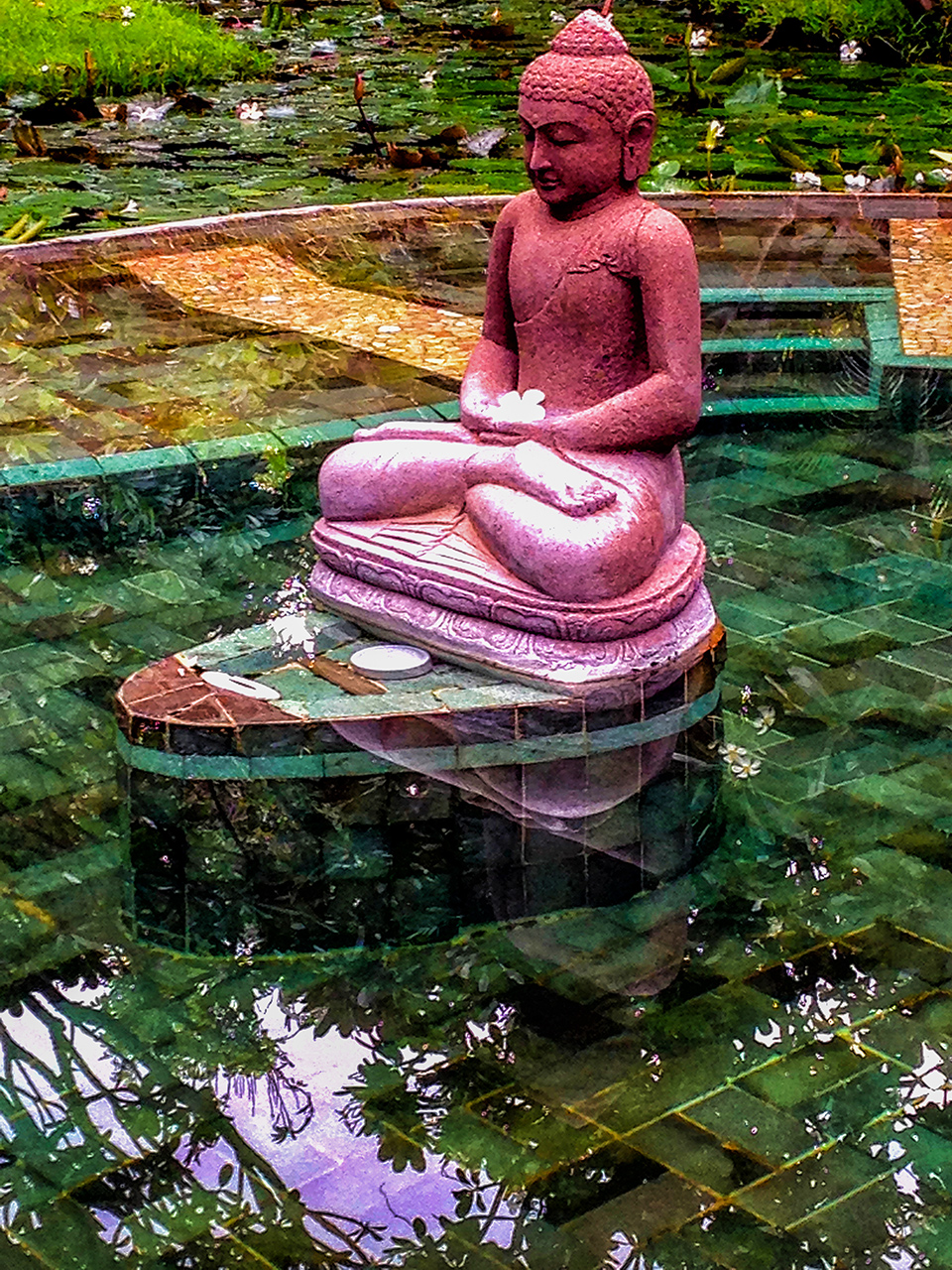 Buddha statue seems to float on the water in Bali Indonesia