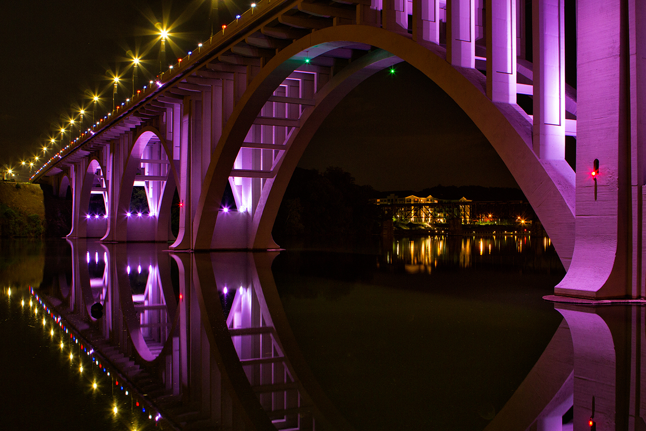 Beautifully lit purple bridge at night in Knoxville Tennessee