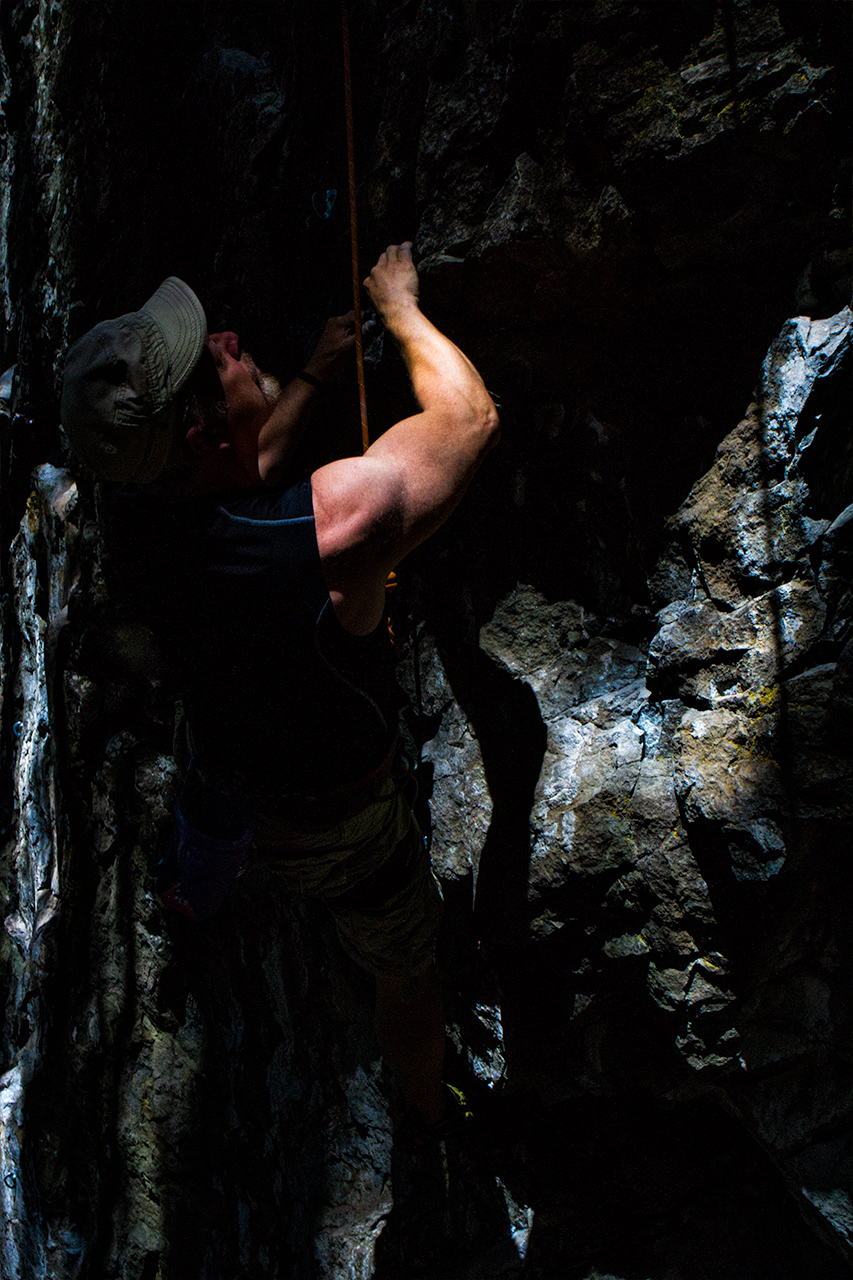 dramatic lighting frames rock climber