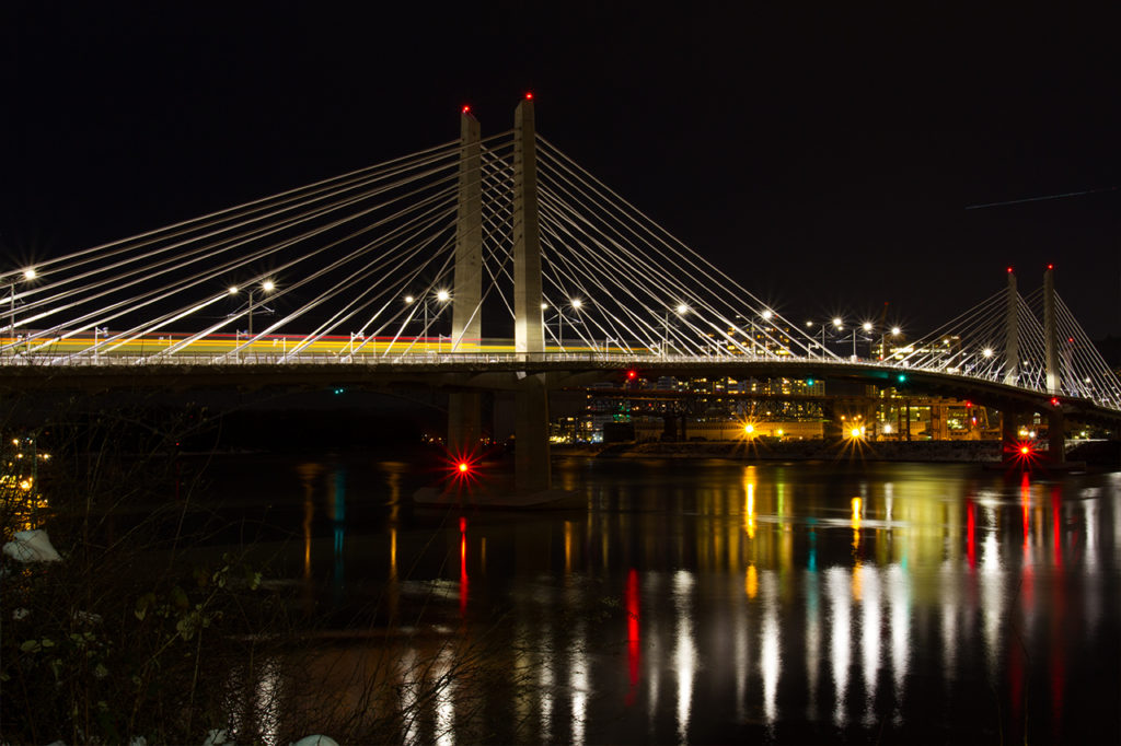 Portland Oregon Tillamook Bridge lit at night with reflection