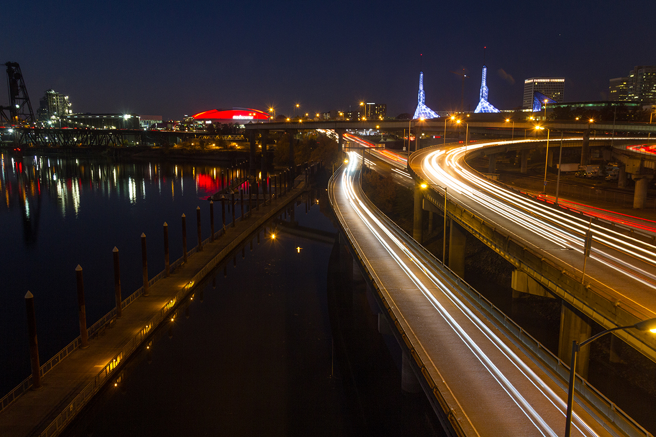 Long exposure night shot of Portland Oregon waterfront and freeways with blurred headlights