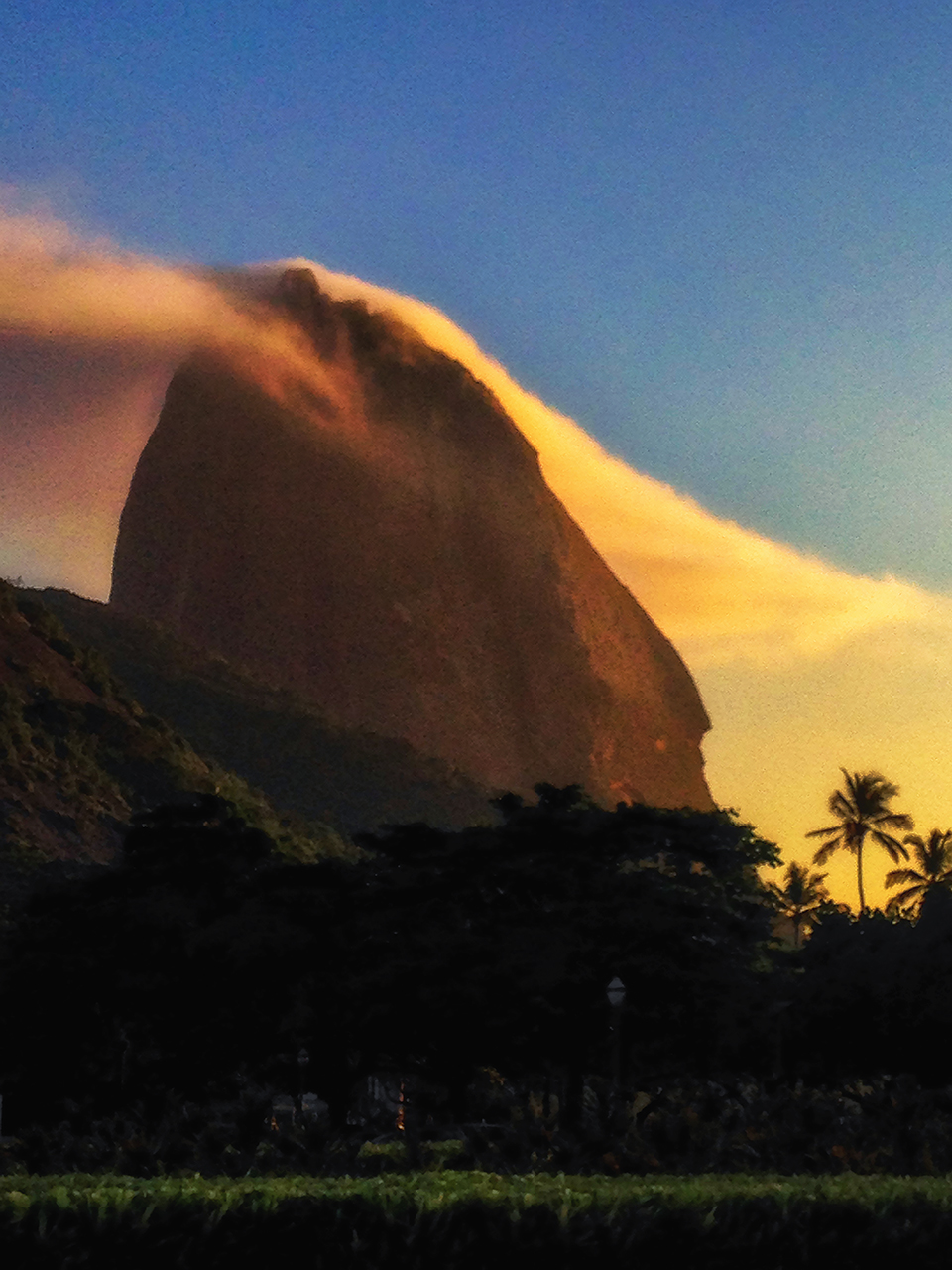 Ethereal clouds at sunrise race over the famed Sugarloaf at Rio de Janeiro in Brazil