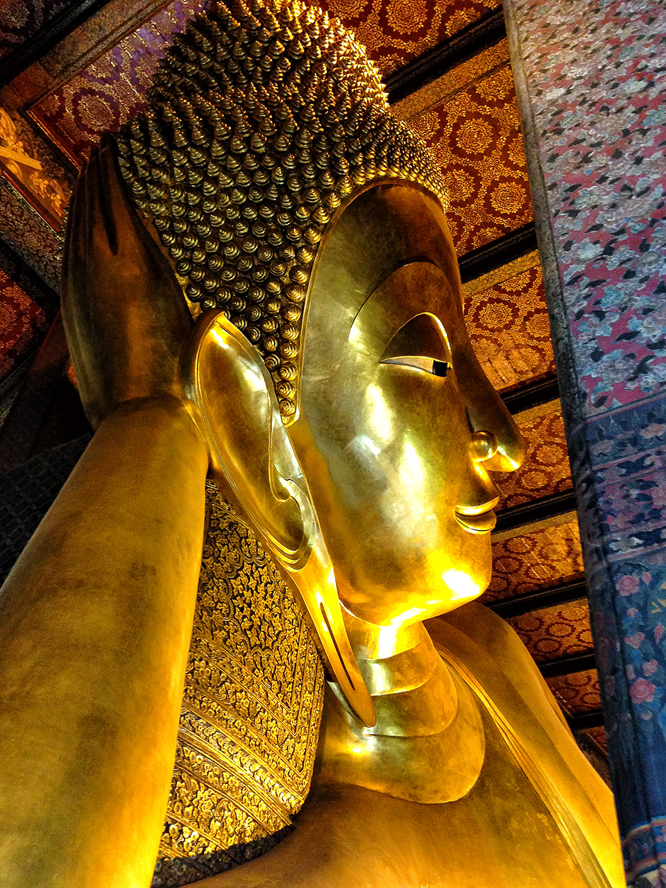 Close upshot of the gigantic 45 meter long Reclining Buddha at Wat Pho in Thailand