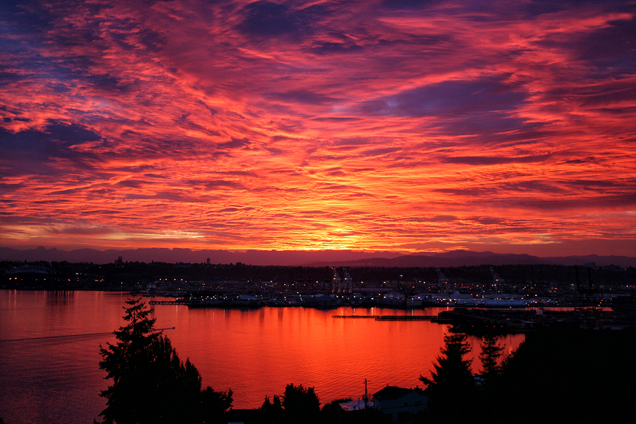 Brilliant sunrise with vivid clouds over Seattle harbor
